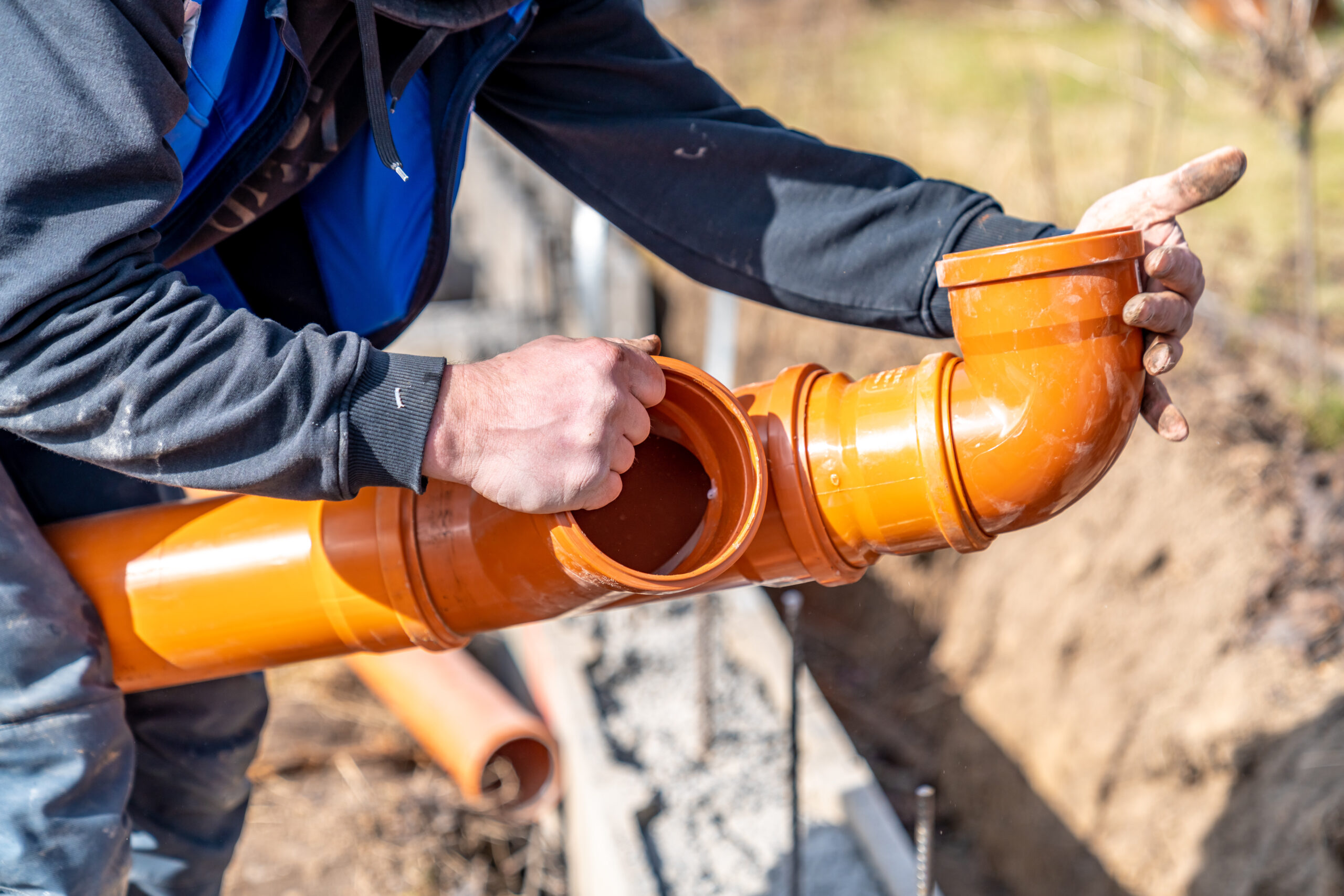 orange PVC plastic pipes on the construction site.